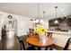 Eat-in kitchen with hardwood floors, granite countertops, and views of the foyer at 415 Damascus Ct, Fairburn, GA 30213