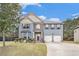 Charming two-story home with a well-manicured lawn, attached two car garage, and classic blue siding at 415 Damascus Ct, Fairburn, GA 30213
