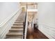 Grand foyer featuring a staircase with wrought iron railing, hardwood floors, and elegant wainscoting at 415 Damascus Ct, Fairburn, GA 30213