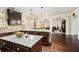 Open kitchen showcases granite countertops, dark wood cabinets, and views to the living area at 415 Damascus Ct, Fairburn, GA 30213