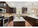 Well-appointed kitchen with stainless steel appliances, granite countertops, and dark wood cabinetry at 415 Damascus Ct, Fairburn, GA 30213
