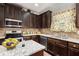 Modern kitchen featuring granite countertops, stainless steel appliances, and ample cabinet space at 415 Damascus Ct, Fairburn, GA 30213