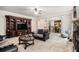 Spacious living room with a built-in entertainment center, fireplace, and open access to the kitchen at 415 Damascus Ct, Fairburn, GA 30213
