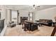 Cozy living room with a stone fireplace, plush sofas, and a view to the stair case landing at 415 Damascus Ct, Fairburn, GA 30213