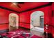 Bright living room with red walls, arched doorways, and dark hardwood floors at 415 Damascus Ct, Fairburn, GA 30213