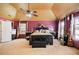 Spacious main bedroom featuring a unique ceiling, ceiling fan, and a decorative bed frame with matching furniture at 415 Damascus Ct, Fairburn, GA 30213