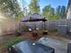 Landscaped backyard with fence, patio and grill at 61 N Auburn Landing Pl, Auburn, GA 30011