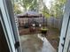 Cozy backyard featuring a wooden fence, umbrella, and patio area at 61 N Auburn Landing Pl, Auburn, GA 30011