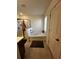 Bright bathroom with tub and shower combination and tile flooring at 61 N Auburn Landing Pl, Auburn, GA 30011