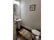 Bathroom with pedestal sink, round mirror, and decorative rug at 61 N Auburn Landing Pl, Auburn, GA 30011