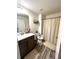 Bathroom with wood-look floors, vanity, and a shower and tub combination at 61 N Auburn Landing Pl, Auburn, GA 30011