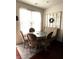 Cozy dining area featuring a tufted bench, round table, and a decorative windowpane wall accent at 61 N Auburn Landing Pl, Auburn, GA 30011