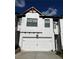Stylish white two-car garage with black hardware and a complementary exterior design creates a welcoming home entrance at 61 N Auburn Landing Pl, Auburn, GA 30011