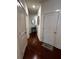 Hallway view showcases hardwood floors, accent table, and 'Home' welcome mat at 61 N Auburn Landing Pl, Auburn, GA 30011