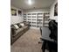 Functional home office featuring built in shelving, desk space and comfortable couch at 61 N Auburn Landing Pl, Auburn, GA 30011