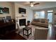 Cozy living room with fireplace, sofa, and large windows at 61 N Auburn Landing Pl, Auburn, GA 30011