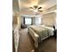 Relaxing main bedroom featuring a tray ceiling, ceiling fan and a large window at 61 N Auburn Landing Pl, Auburn, GA 30011