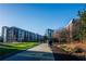 Apartment buildings with walking path, grass, and trees on a sunny day at 821 Ralph Mcgill Ne Blvd # 3337, Atlanta, GA 30306