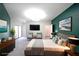 This staged primary bedroom showcases a king-size bed, a TV, and access to a private balcony at 821 Ralph Mcgill Ne Blvd # 3337, Atlanta, GA 30306