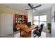 This office has a ceiling fan, a modern desk, built-in shelves and a window overlooking trees at 821 Ralph Mcgill Ne Blvd # 3337, Atlanta, GA 30306