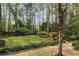 A beautiful backyard provides a tranquil setting with greenery and mature trees at 1244 Arden Sw Dr, Marietta, GA 30008