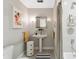 Small bathroom with pedestal sink, neutral decor, and striped shower curtain at 1244 Arden Sw Dr, Marietta, GA 30008