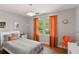 Bright bedroom with large window, orange curtains, and simple decor at 1244 Arden Sw Dr, Marietta, GA 30008