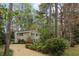 The house has a large yard and mature trees, creating a picturesque setting at 1244 Arden Sw Dr, Marietta, GA 30008