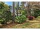 The house has a large yard and mature trees, creating a picturesque setting at 1244 Arden Sw Dr, Marietta, GA 30008