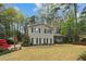 Well-maintained front yard with mature trees frames this two-story home with black shutters at 1244 Arden Sw Dr, Marietta, GA 30008