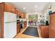 Well-lit kitchen with stainless steel appliances, dark countertops, and wooden cabinets at 1244 Arden Sw Dr, Marietta, GA 30008