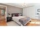 Comfortable main bedroom featuring hardwood floors, modern lighting, and ample closet space at 1244 Arden Sw Dr, Marietta, GA 30008