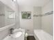 Bathroom featuring granite countertop, modern fixtures, and tiled shower at 1879 Shamrock Dr, Decatur, GA 30032