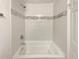 Clean bathroom featuring a tiled bathtub with shower and modern fixtures at 1879 Shamrock Dr, Decatur, GA 30032