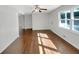 Open-concept living room with hardwood floors, ceiling fan, and a view to the outside at 1879 Shamrock Dr, Decatur, GA 30032