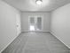 Bedroom with neutral carpet and double doors leading to deck at 4425 Amy Rd, Snellville, GA 30039