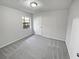 Bright bedroom with neutral carpet, one window and white door at 4425 Amy Rd, Snellville, GA 30039