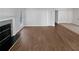 Open-concept living room with hardwood floors and a cozy fireplace at 4425 Amy Rd, Snellville, GA 30039