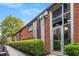 Attractive brick exterior of townhome with large windows, green landscaping, and clear unit number at 5200 Peachtree Rd # 2116, Atlanta, GA 30341