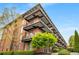 A multi-story brick condominium building showcasing private balconies at 5200 Peachtree Rd # 2116, Atlanta, GA 30341