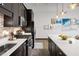 Contemporary kitchen with stainless steel appliances, a breakfast bar, a tiled backsplash, and dark cabinets at 5200 Peachtree Rd # 2116, Atlanta, GA 30341