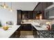 Well-equipped kitchen featuring granite countertops, stainless steel appliances, dark cabinetry, and modern fixtures at 5200 Peachtree Rd # 2116, Atlanta, GA 30341