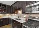 Updated kitchen features stainless steel appliances, a tiled backsplash, granite countertops, and modern fixtures at 5200 Peachtree Rd # 2116, Atlanta, GA 30341
