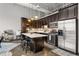 Modern kitchen features dark cabinets, stainless steel appliances, a central island, and stylish pendant lighting at 5200 Peachtree Rd # 2116, Atlanta, GA 30341