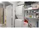 Efficient laundry room with stacked washer and dryer, shelving, and ample storage space at 5200 Peachtree Rd # 2116, Atlanta, GA 30341