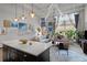 Open-concept living space featuring a kitchen island, comfortable seating, and large windows for ample natural light at 5200 Peachtree Rd # 2116, Atlanta, GA 30341