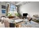 Stylish living room featuring a large window, plants, plush seating, and an open floor plan at 5200 Peachtree Rd # 2116, Atlanta, GA 30341