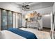 Bright main bedroom with ceiling fan, string lights, wardrobe, dresser, and decorative accents at 5200 Peachtree Rd # 2116, Atlanta, GA 30341