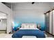 Bright main bedroom with blue accent wall, string lights, ceiling fan, and large wardrobe at 5200 Peachtree Rd # 2116, Atlanta, GA 30341