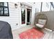 Cozy back porch featuring an egg chair, an outdoor rug, and an entrance to the home at 1494 Addison Pl, Decatur, GA 30033